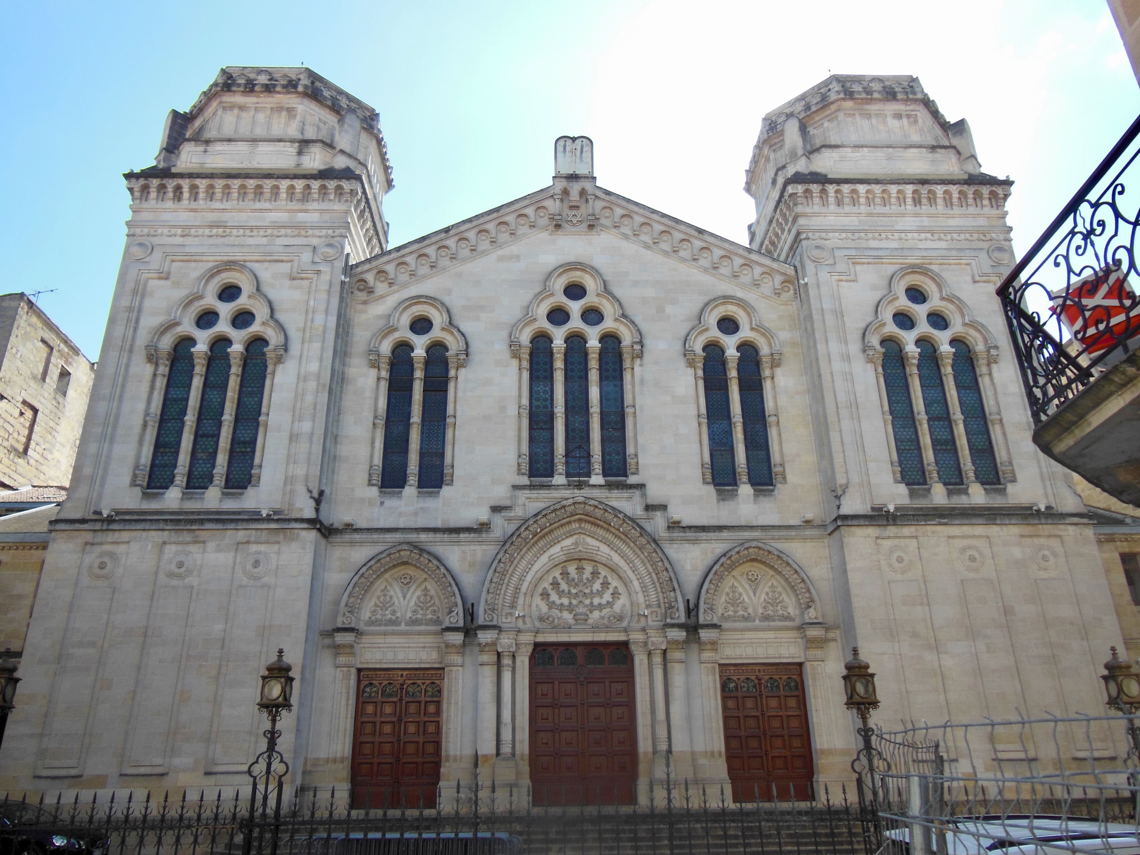 Picture of front of synagogue of Roman motif showing large marble steps leading up to the entrance, flanked by 2 large towers on either side